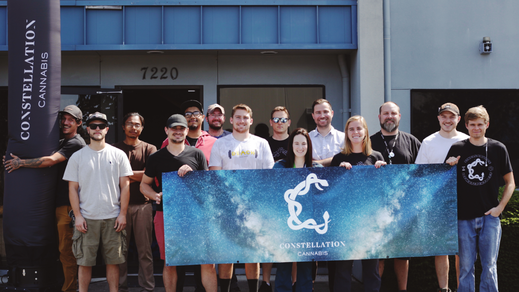 A picture of the Constellation Cannabis team holding up their banner
