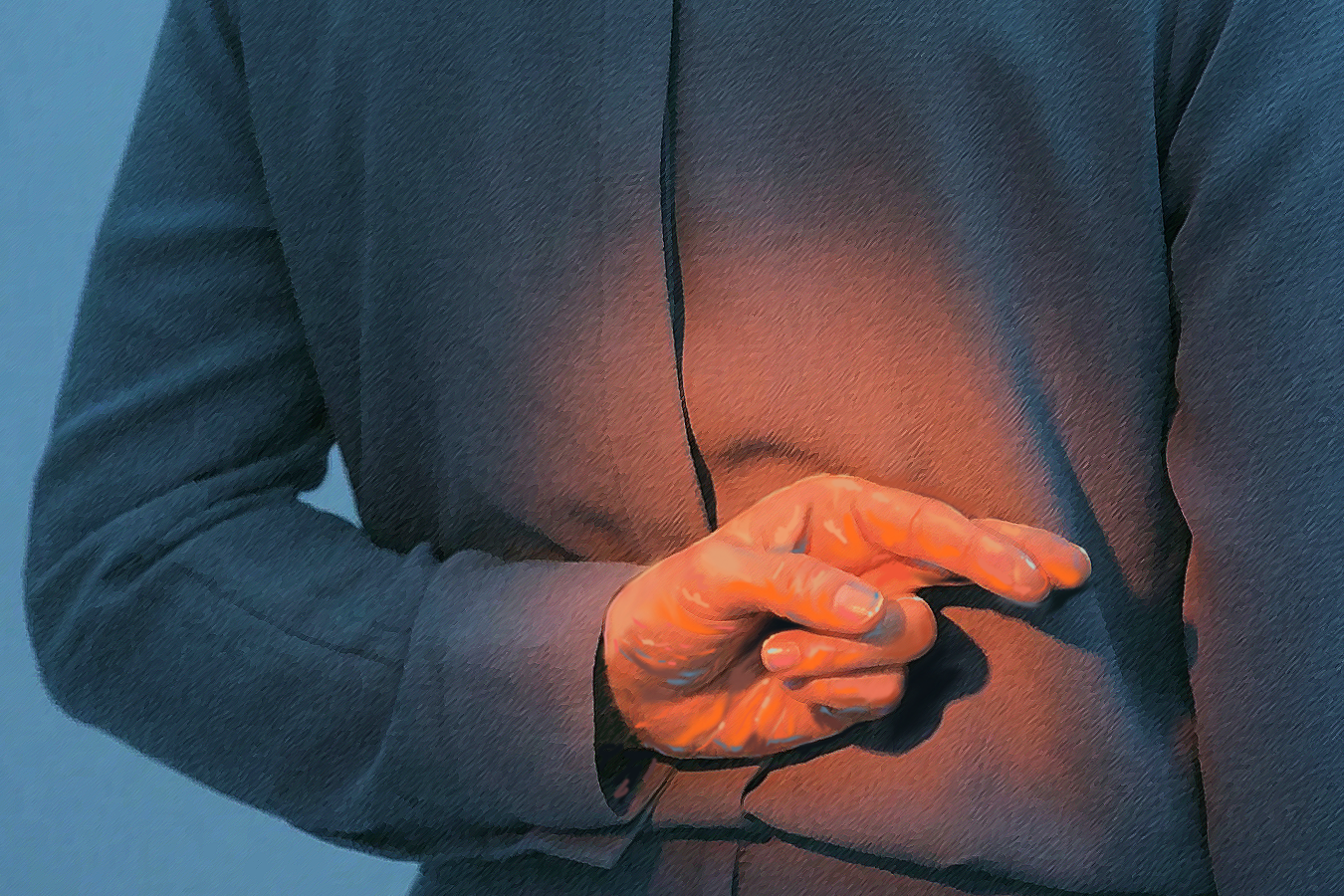 A person in a dark blue shirt stands with their back partially turned, holding one hand behind their back with fingers crossed. Warm light highlights the hand, subtly evoking themes of website privacy and secrecy in the internet in 2025.